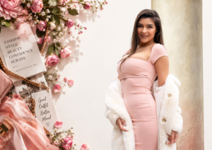 “Woman wearing a stylish pink fitted dress and white coat in a feminine fashion setting”