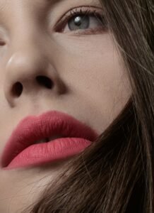 flawless make-up Close-up beauty portrait featuring soft eye makeup, defined lashes, glowing skin, and rosy pink lipstick