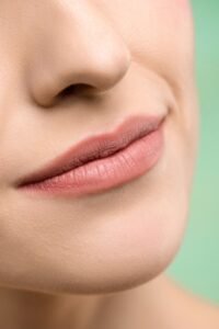 Close-up of natural nude pink lips with a soft matte finish for an elegant everyday makeup look