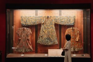 Traditional embroidered dresses displayed in a fashion museum exhibit
