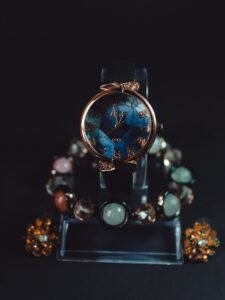 Elegant women’s fashion watch with blue dial and colorful gemstone bracelet
