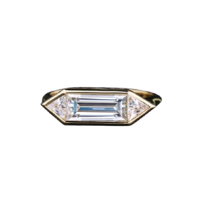 Elegant emerald-cut diamond ring with geometric gold setting and tapered side stones